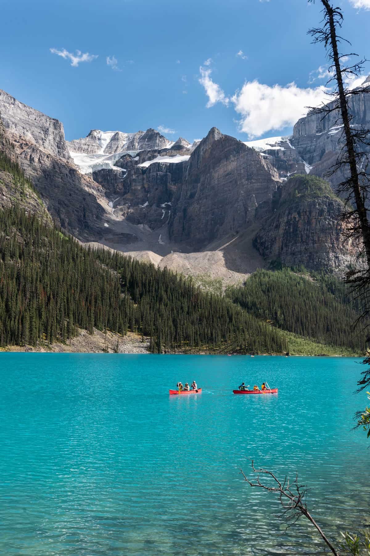 Canoes on turquoise water at Lake Moraine.