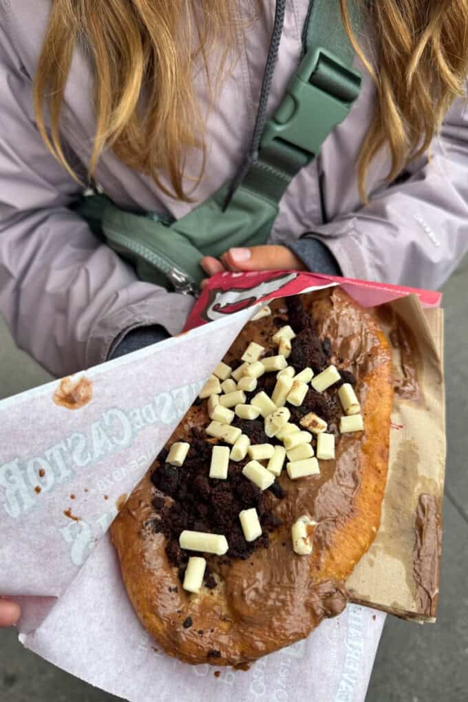 A beaver tail pastry with white chocolate sprinkles on top.