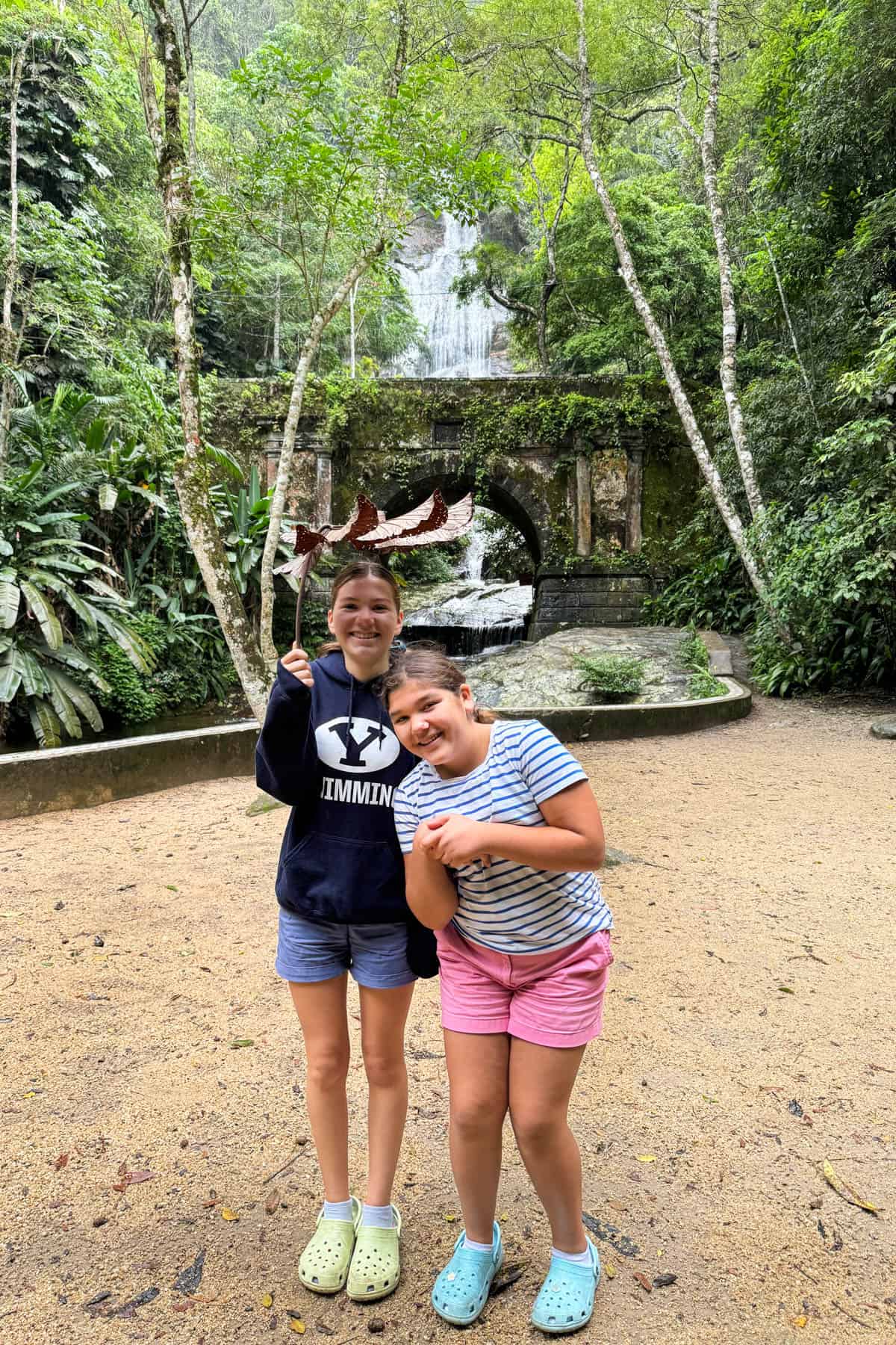 Two sisters huddled under a giant leaf at a national park in Brazil.