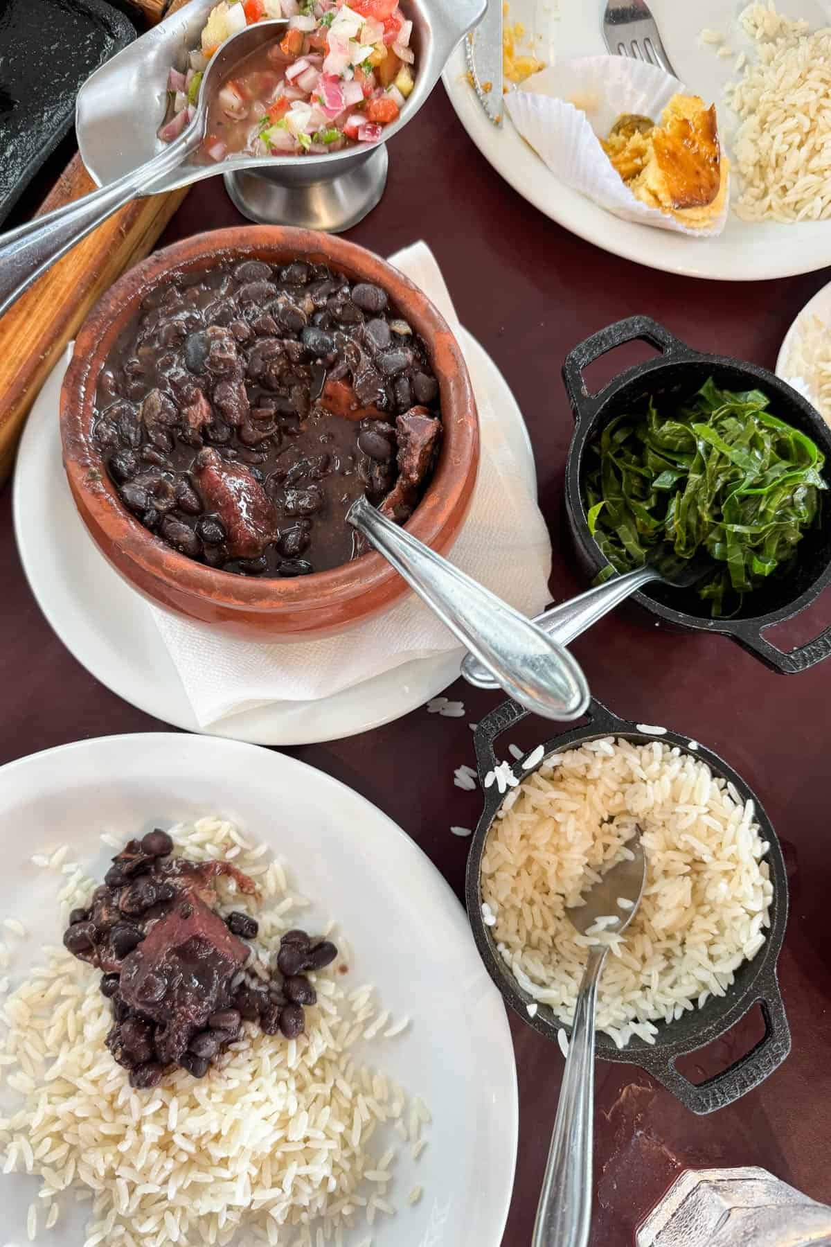 A traditional Brazilian meal with beans, rice, and greens.