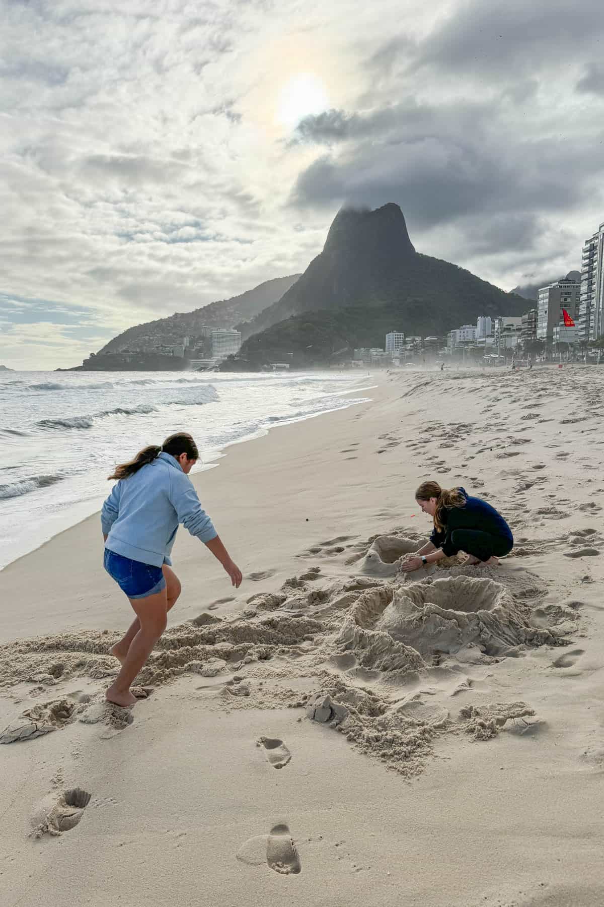 Kids playing in the sand at Ipanema beach.