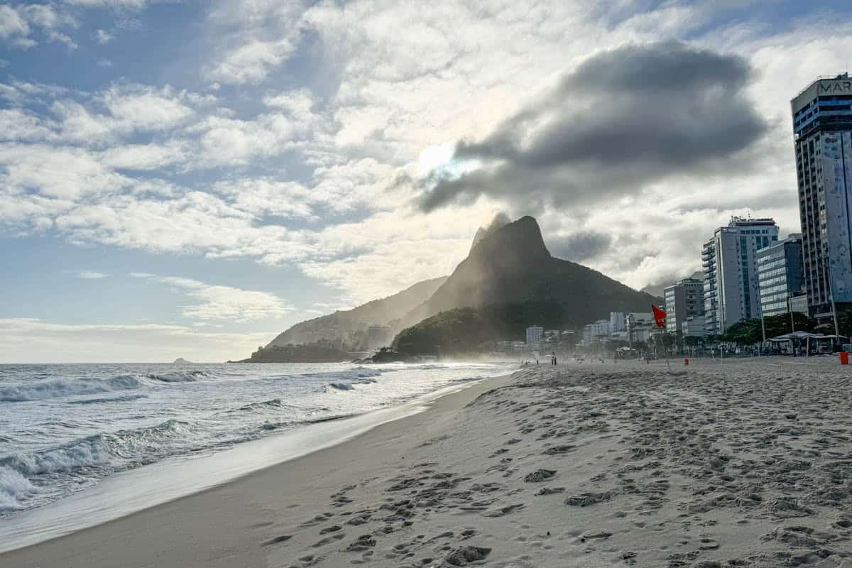 An image of the beach in Rio de Janeiro with a mountain in the background.