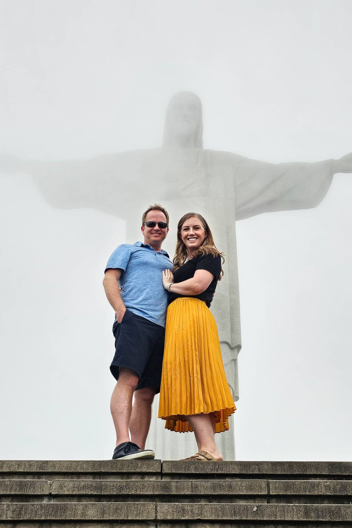 A couple in front of the Christ the Redeemer statue in Rio de Janeiro, Brazil.