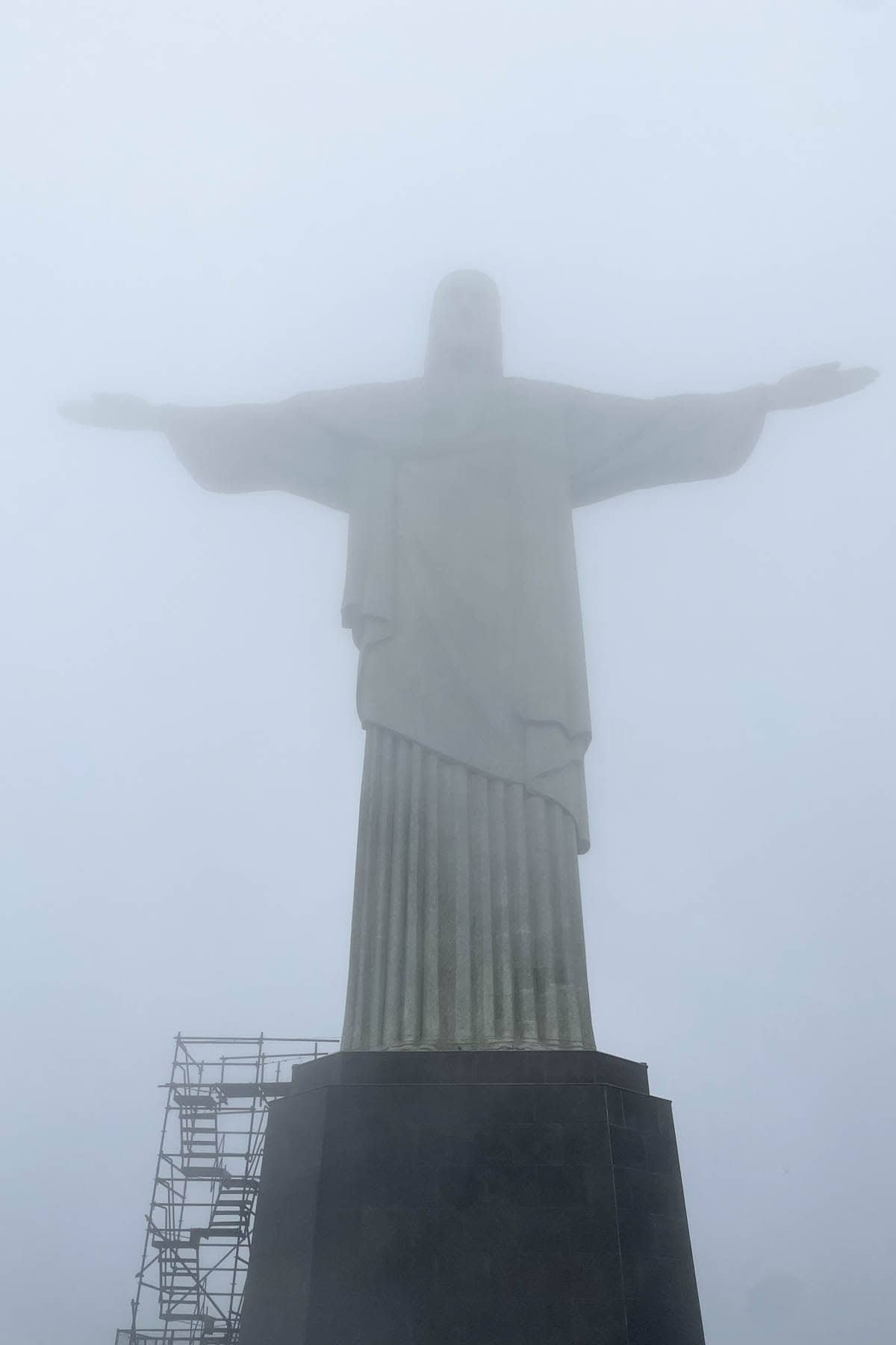 The Christ the Redeemer statue in Rio de Janeiro almost completely shrouded in fog.