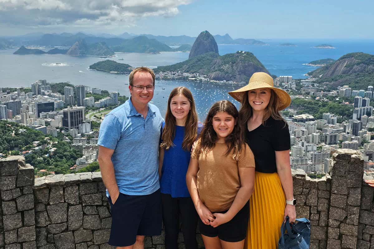 A family in Rio de Janeiro with Sugarloaf Mountain in the background.