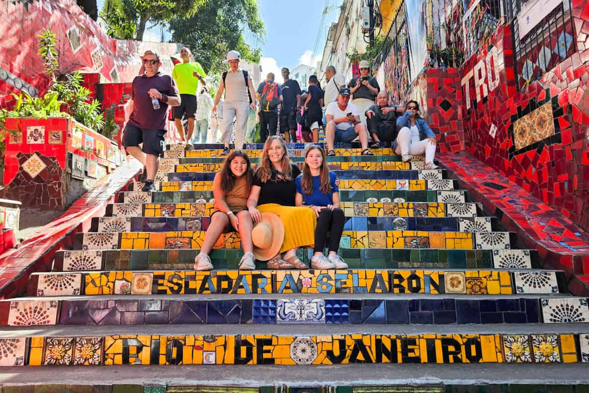 A mom and daughters sitting on the escadarin selaron stairs in Rio de Janeiro.