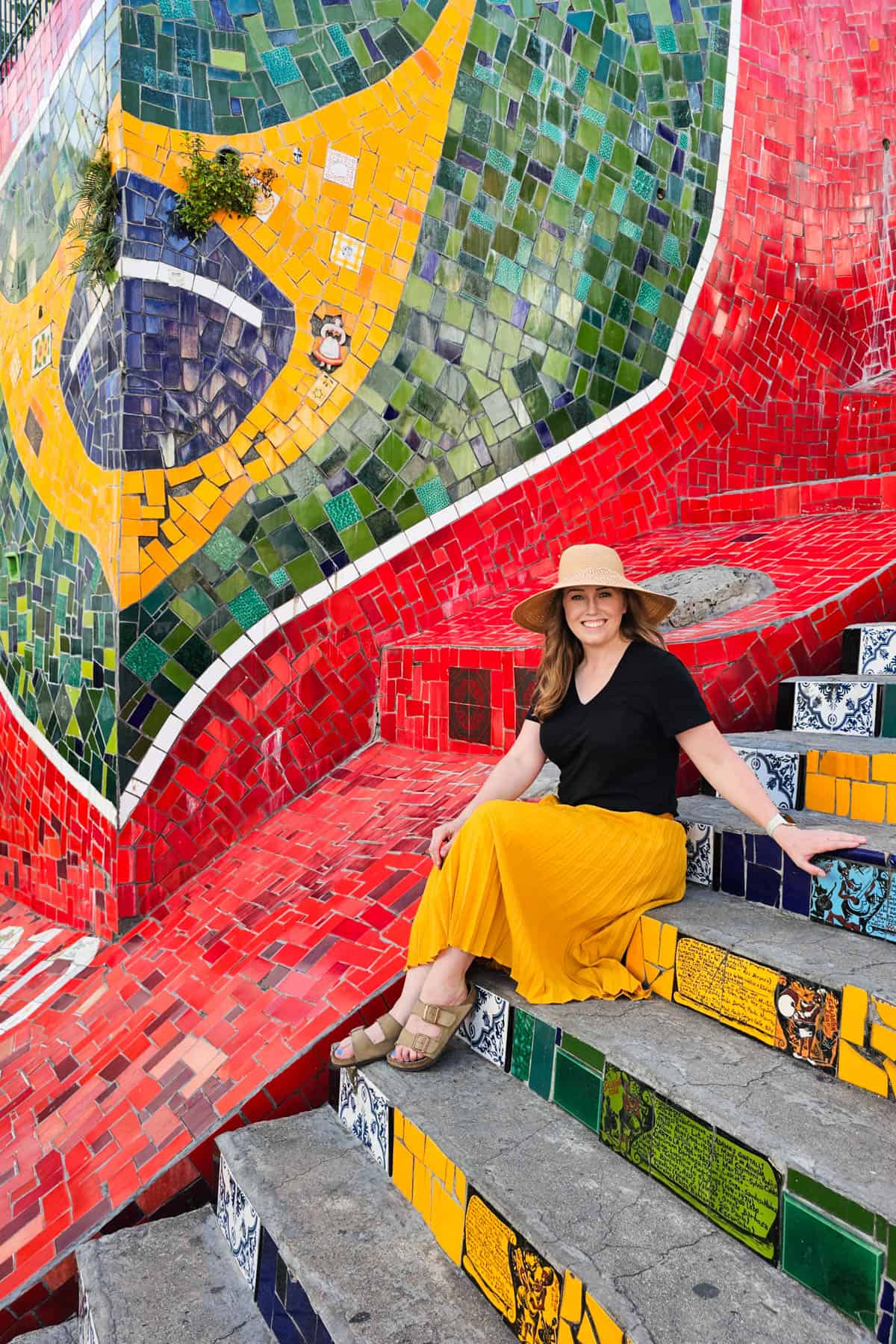 A woman sitting on the tiled steps in Rio de Janeiro.