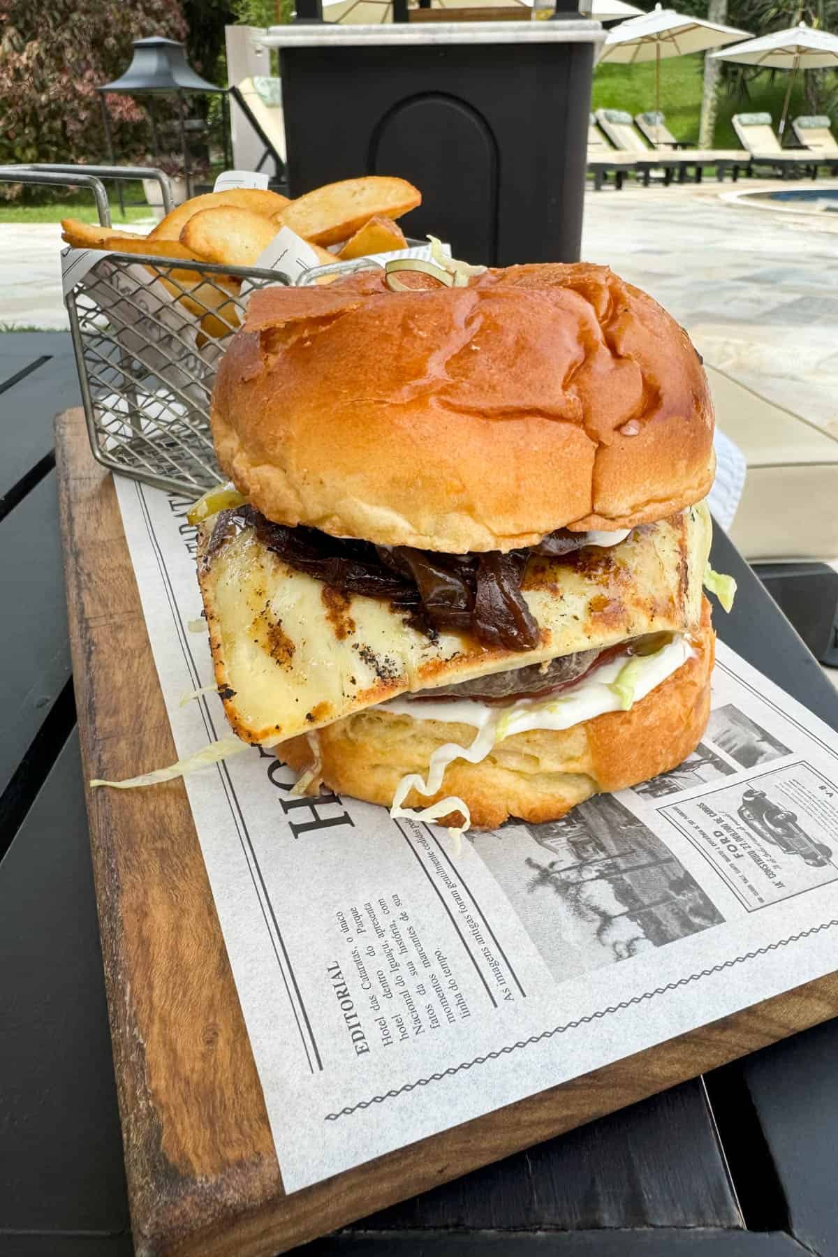A hamburger on newsprint parchment paper.