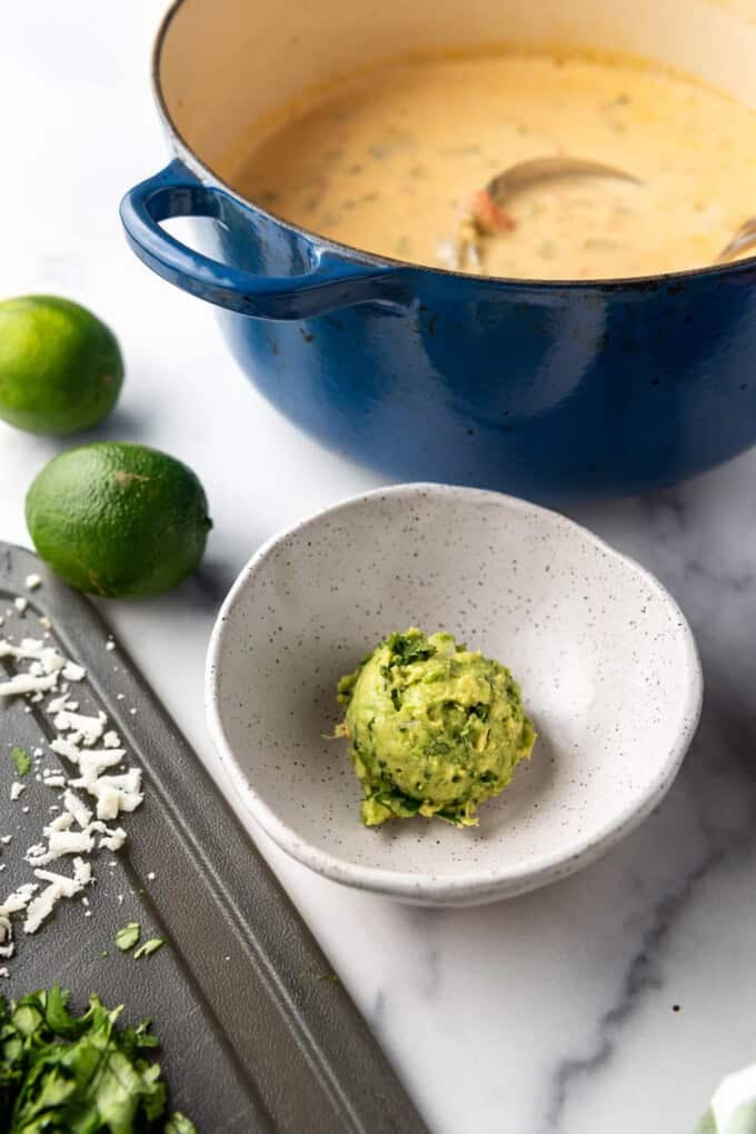 A scoop of fresh guacamole in a bowl.