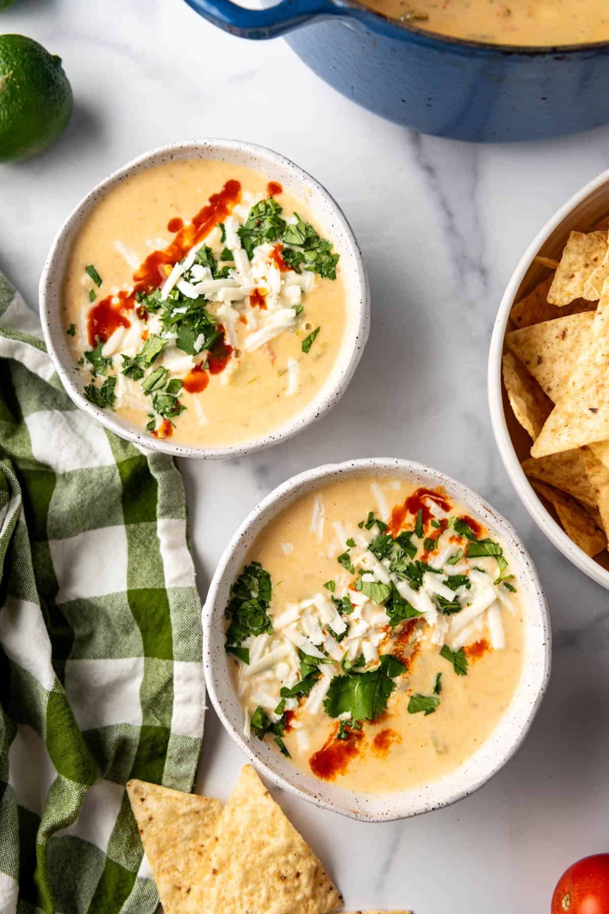 An overhead image of two bowls of copycat Torchy's queso dip.