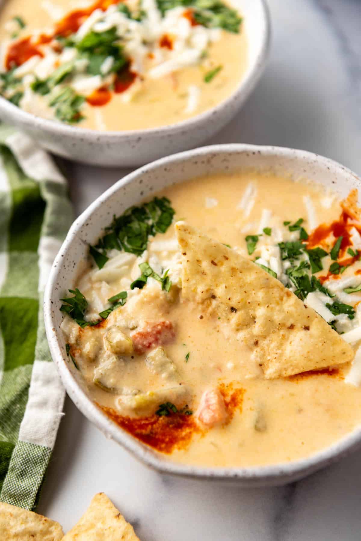 A chip in a bowl of queso.