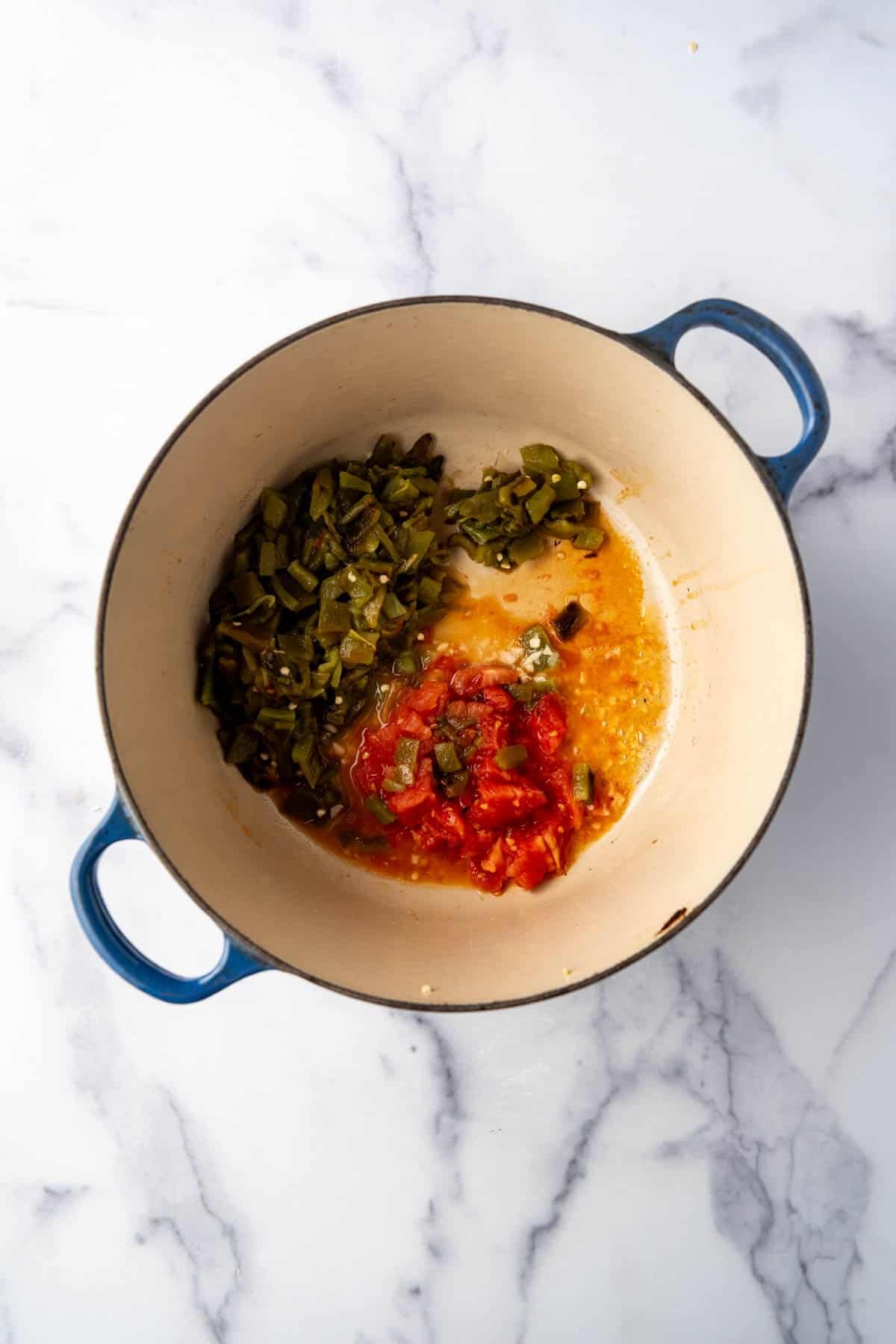 Sauteeing diced roasted veggies in a dutch oven.