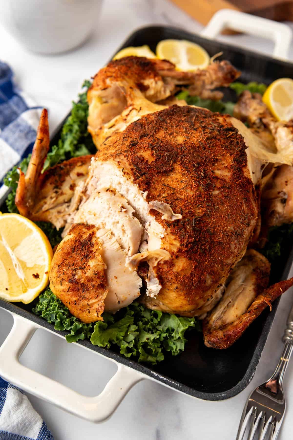 An image of a partially sliced roasted chicken.