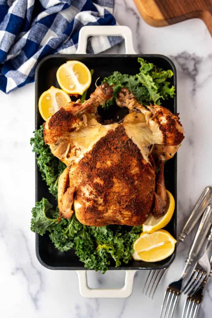An overhead image of a roasted chicken on a serving platter.