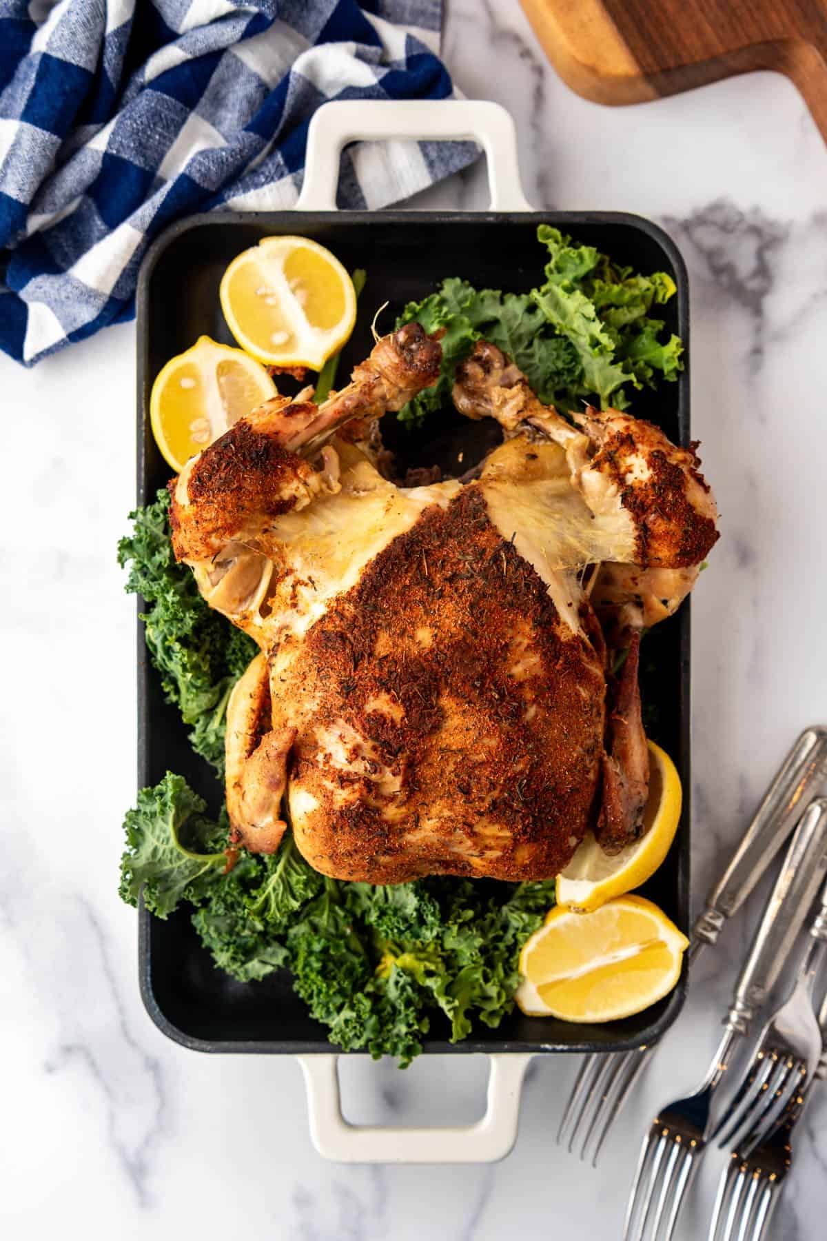 An overhead image of a roasted chicken on a serving platter.