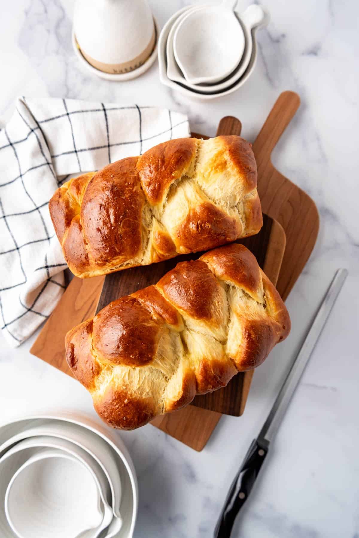 An overhead image of two loaves of braided brioche bread.