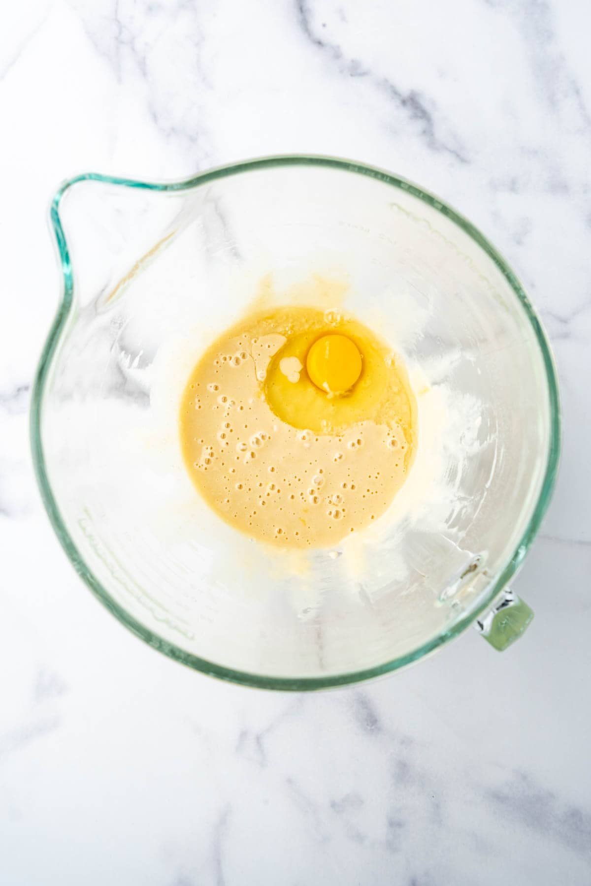 Adding eggs one at a time to brioche dough.