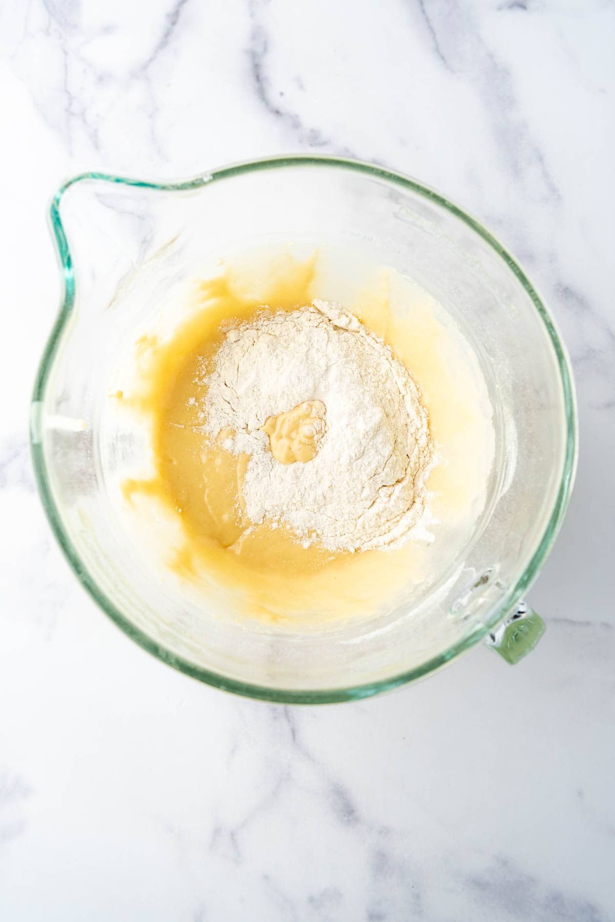 Adding more flour to brioche bread dough.