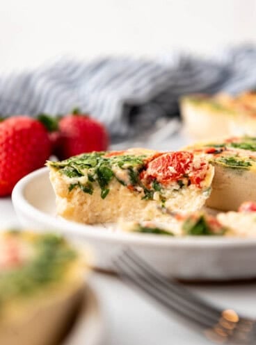 An image of egg white bites with a bite taken out of one of them.