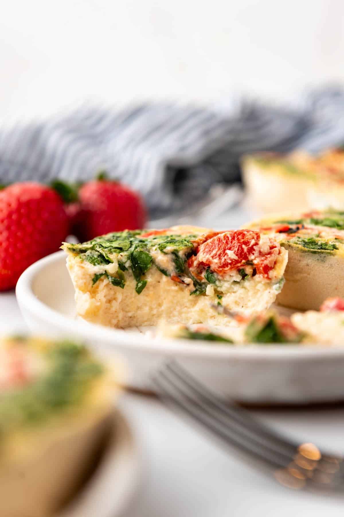 An image of egg white bites with a bite taken out of one of them.