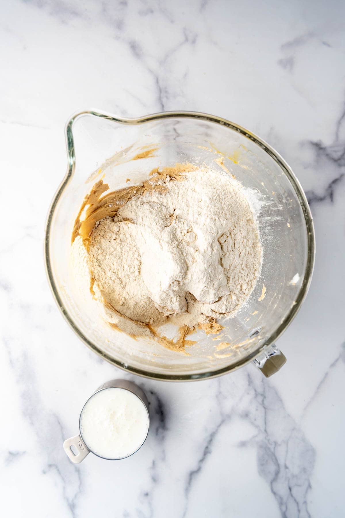 Adding dry ingredients to cake batter alternately with buttermilk.