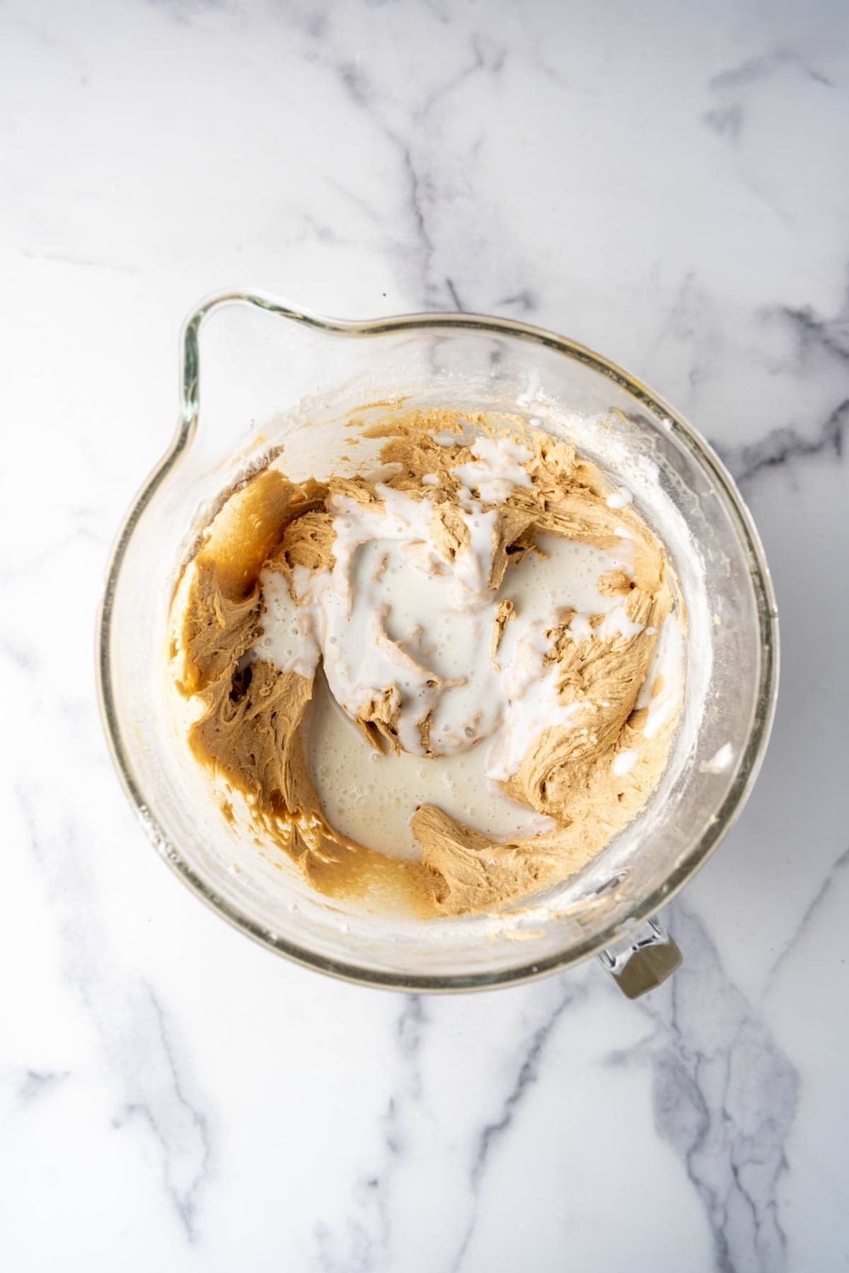 Adding buttermilk to cake batter alternately with flour.