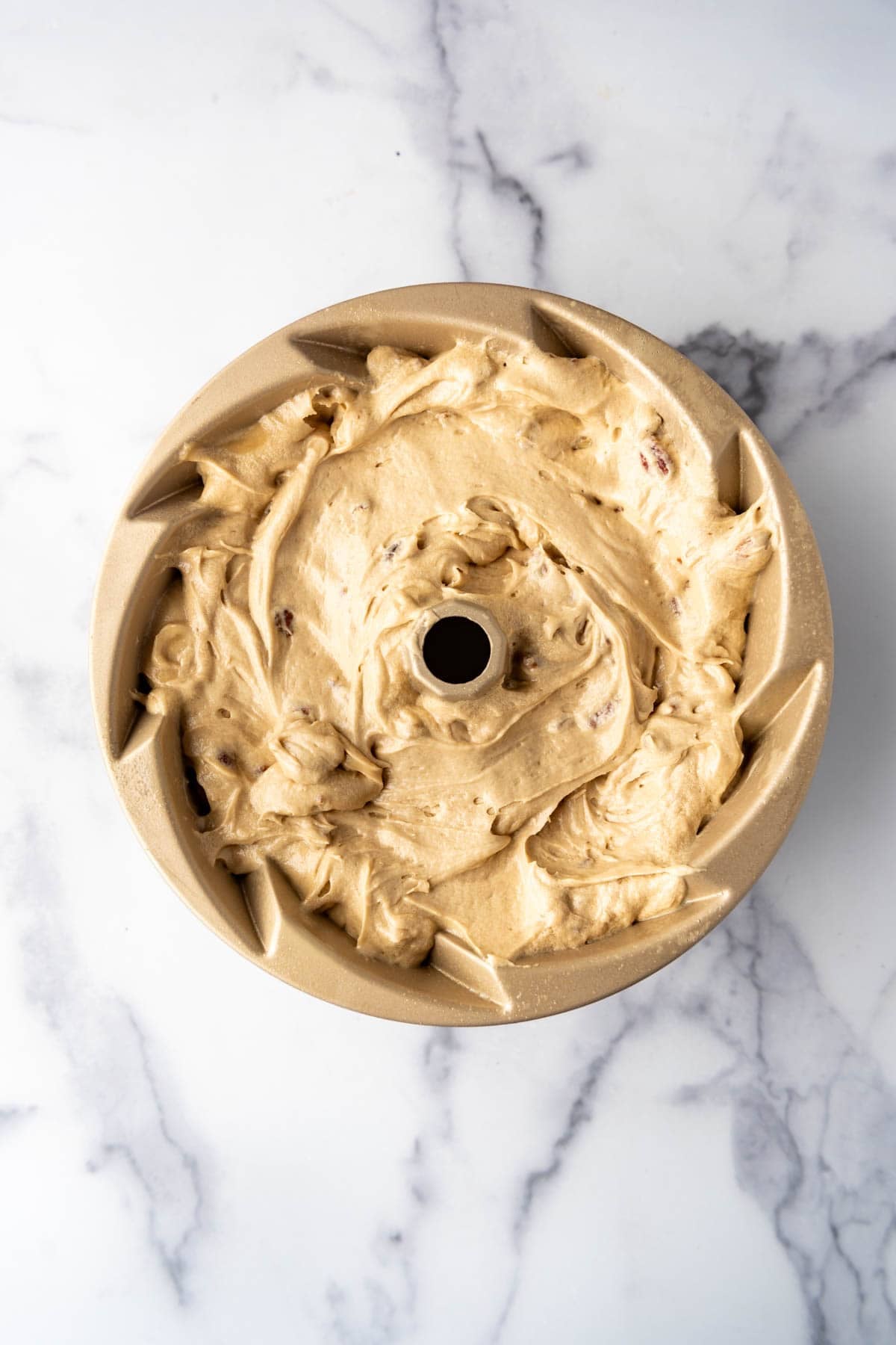 Cake batter in a bundt pan.