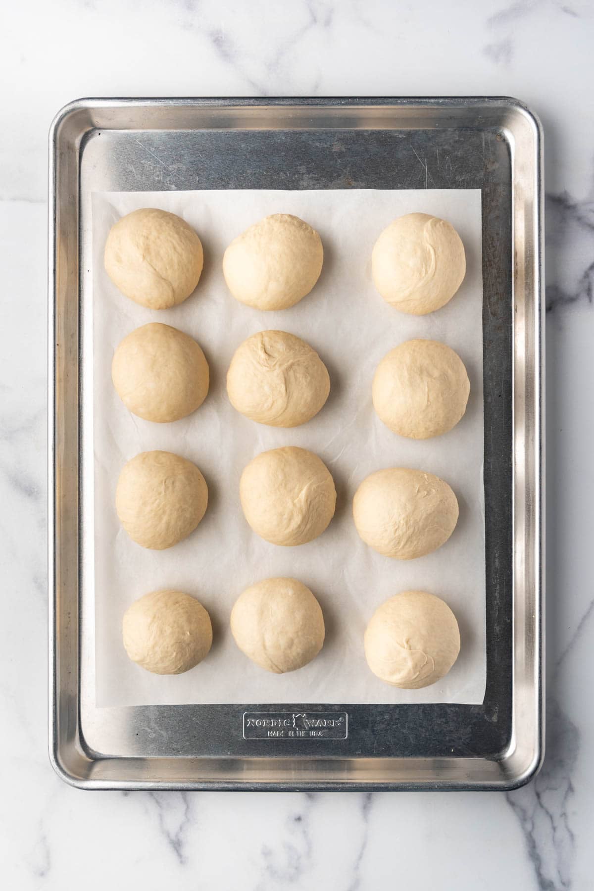 Balls of dough on a baking sheet.