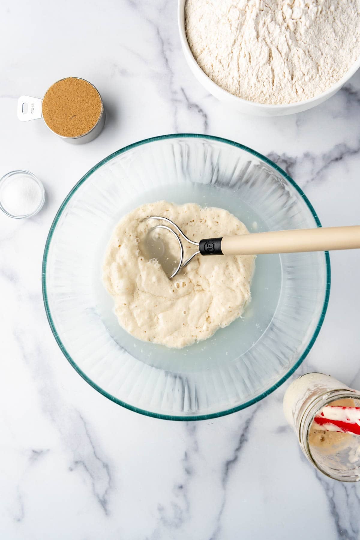 Sourdough starter and water in a mixing bowl.