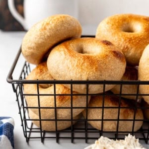 A wire basket of sourdough bagels.