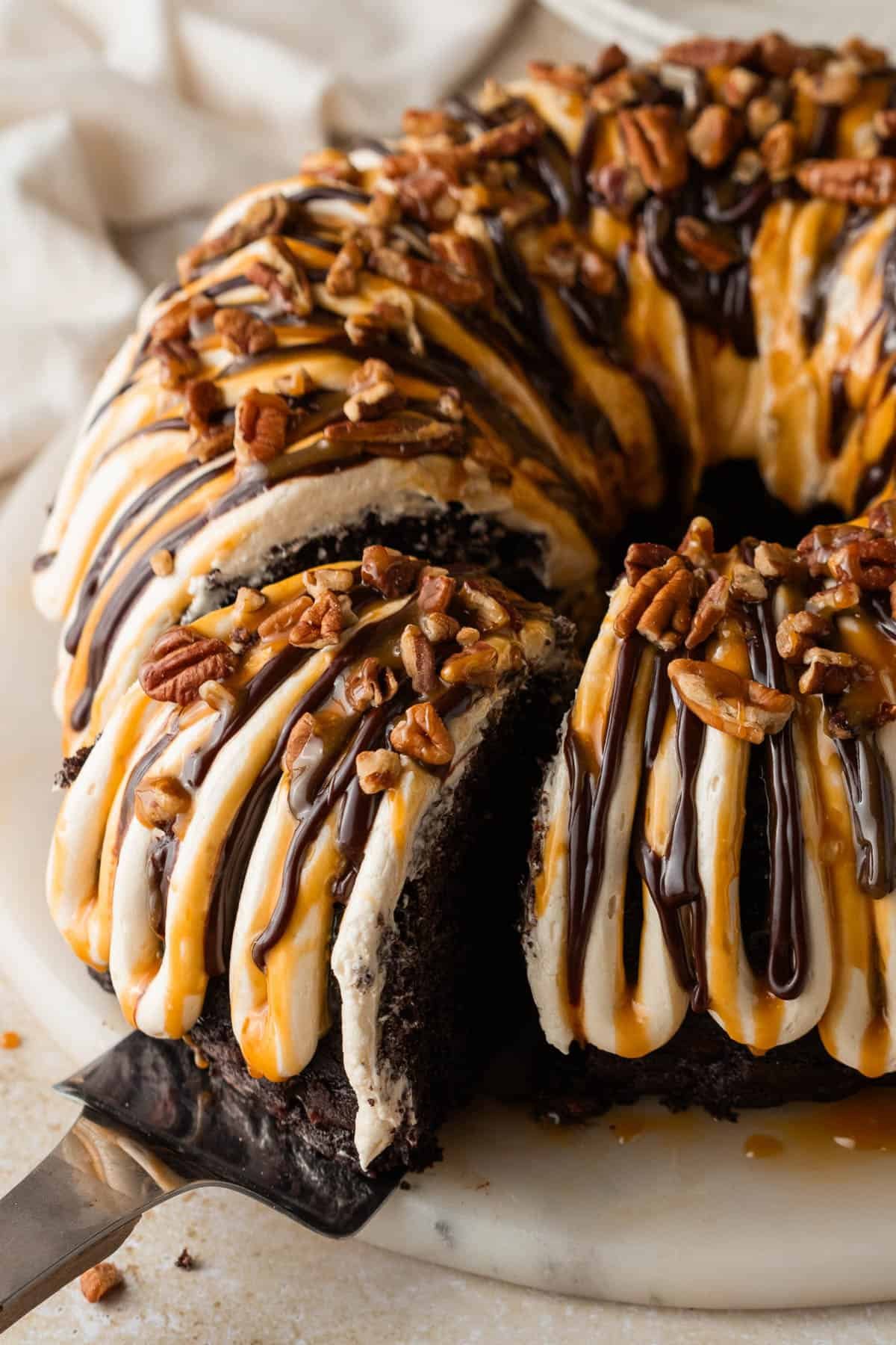 A slice of cake being pulled out of the rest of the cake.