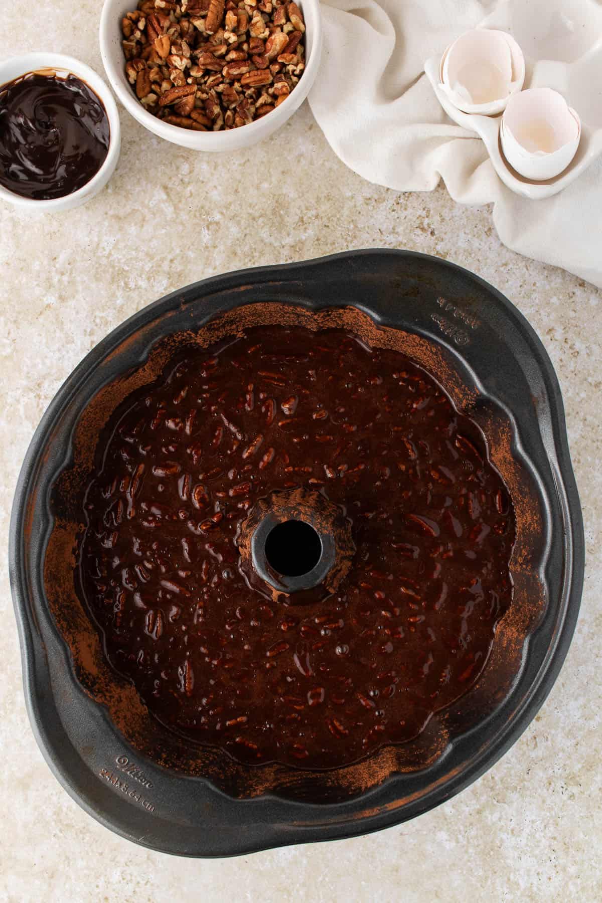 A bundt pan filled with chocolate cake batter.