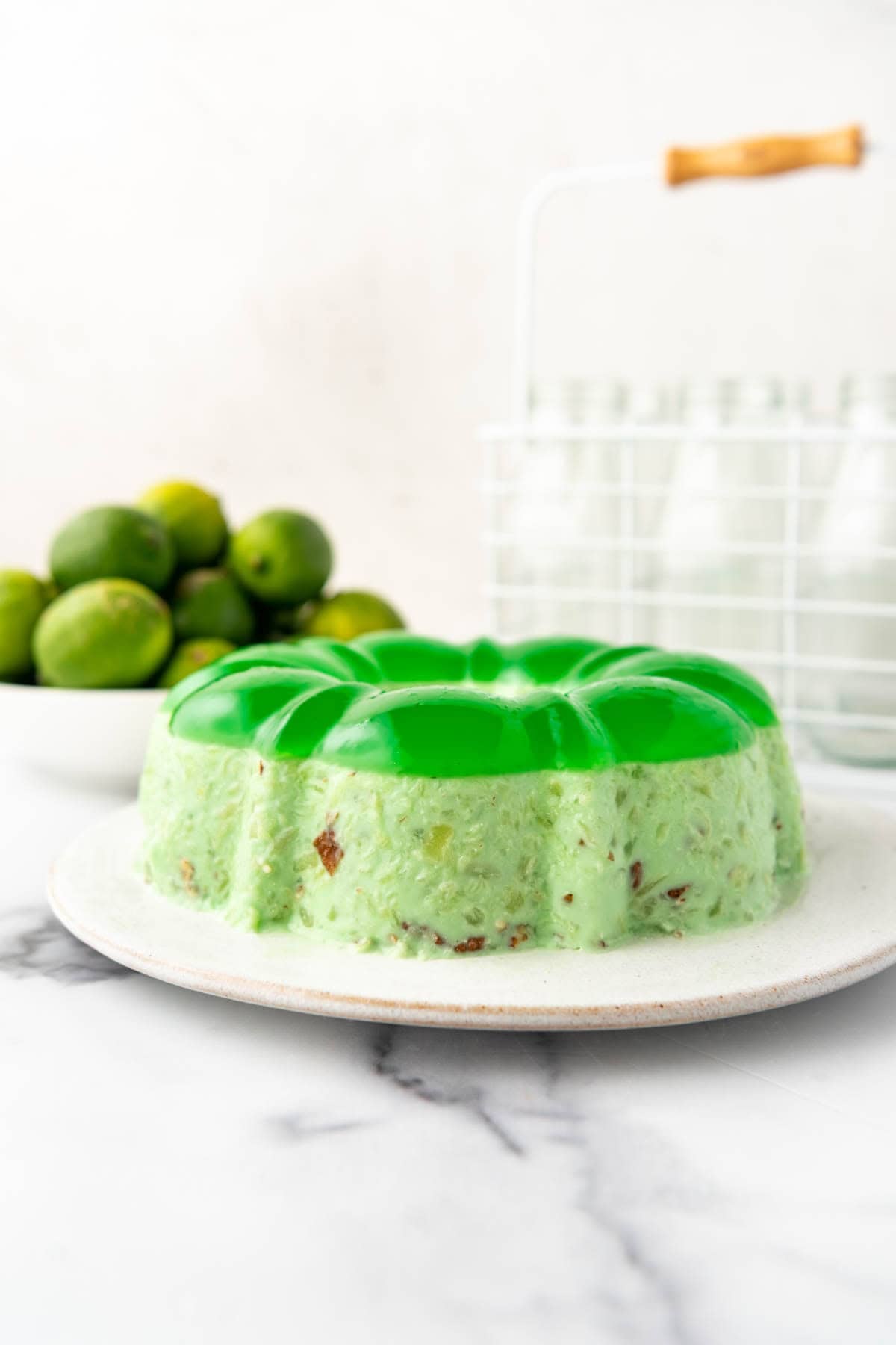 A molded lime green jello on a plate.