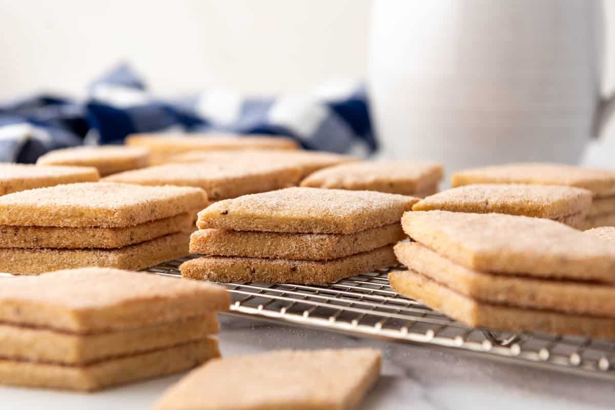 An image of stacks of biscochitos on a wire rack.
