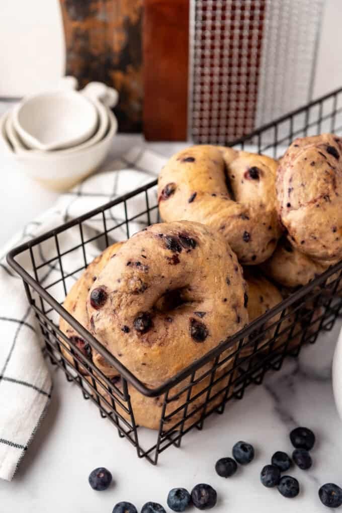 A basket of fresh blueberry bagels.