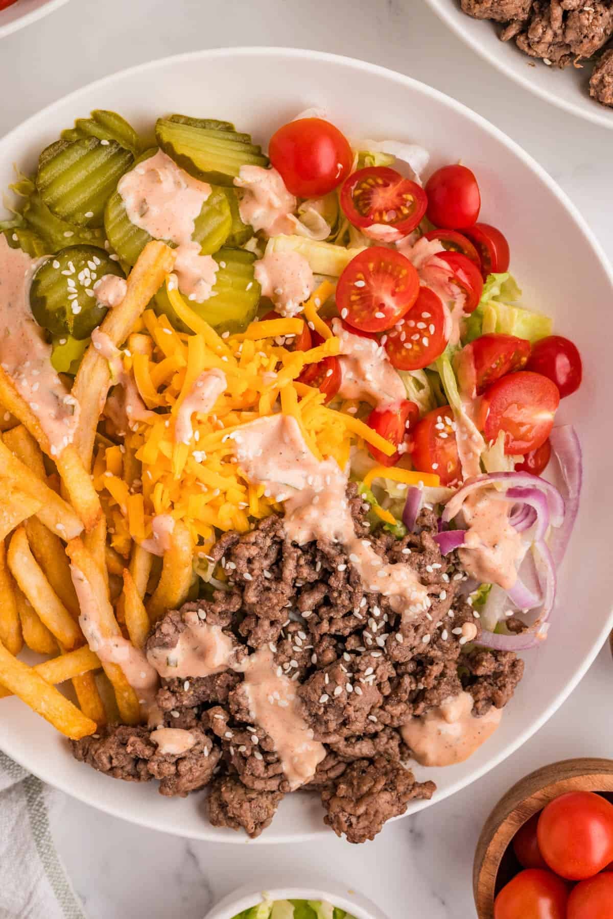 A close image of a burger bowl with sauce.