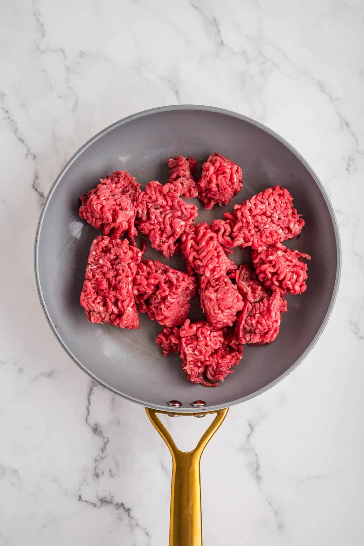 An overhead image of ground beef in a skillet.