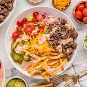 An overhead image of a burger bowl with fries.