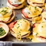 Eggs benedict with hollandaise sauce and chives.
