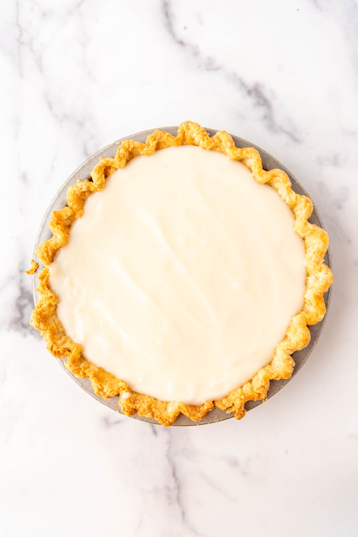 A layer of coconut filling on top of a pie.