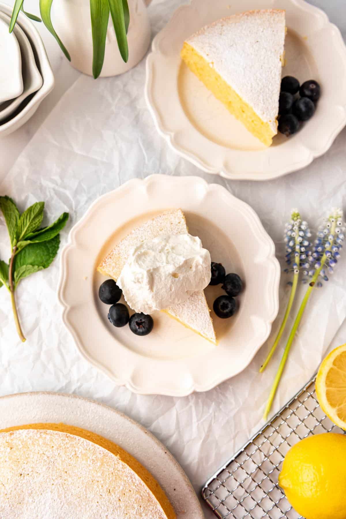 Slices of lemon olive oil cake on white plates.