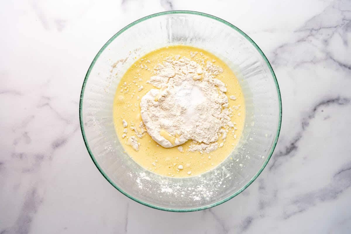 Adding dry ingredients to olive oil cake batter.