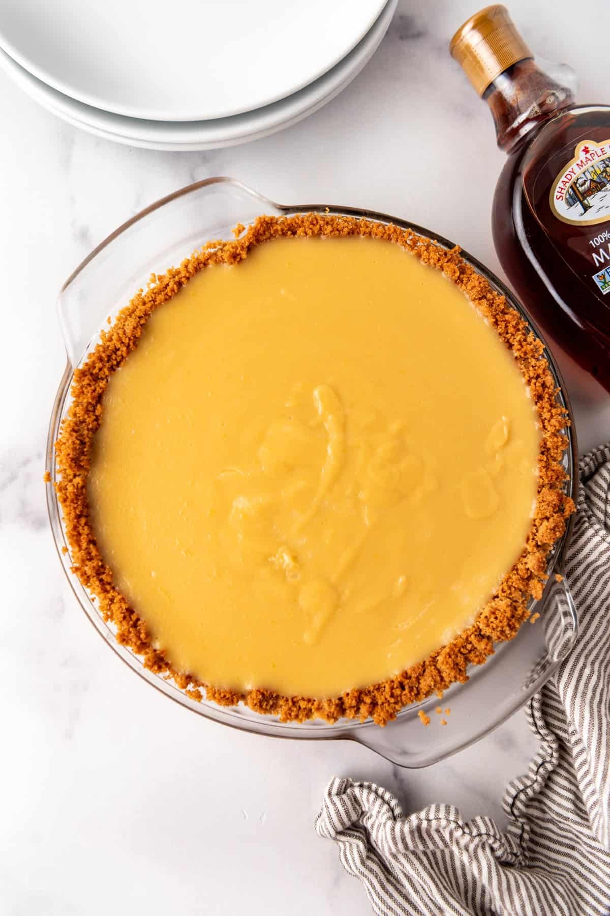 An overhead image of a filled maple cream pie that has been chilled in the fridge before adding whipped cream topping.