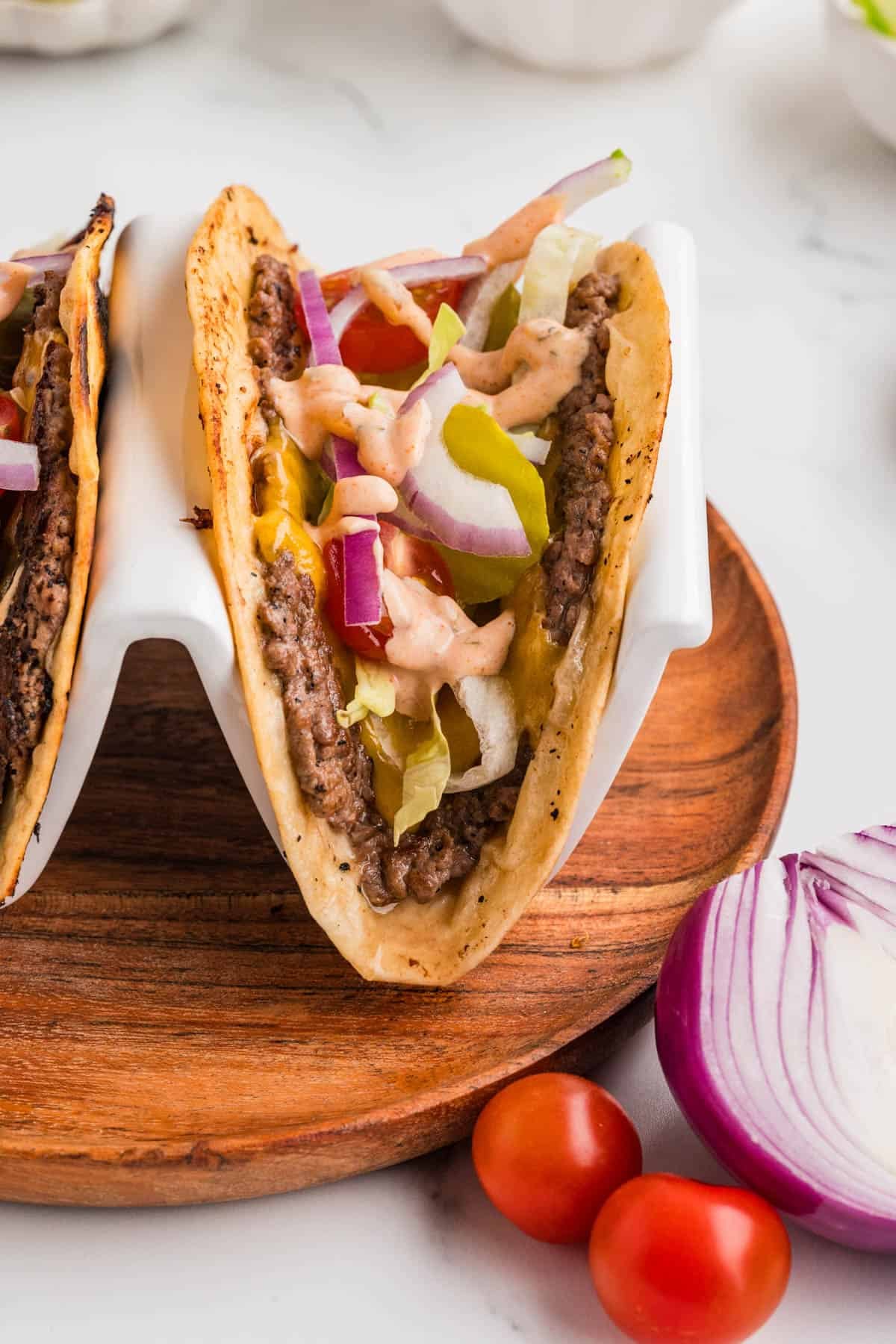 Smash burger tacos in a taco holder.