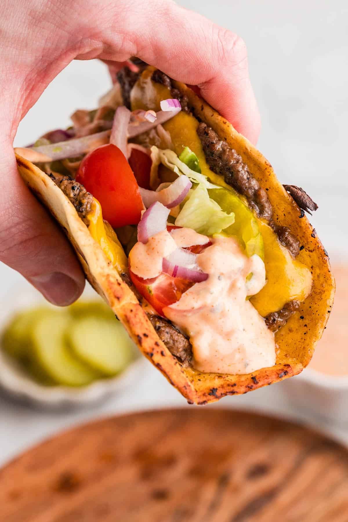 A copycat smash burger taco ready to be eaten.