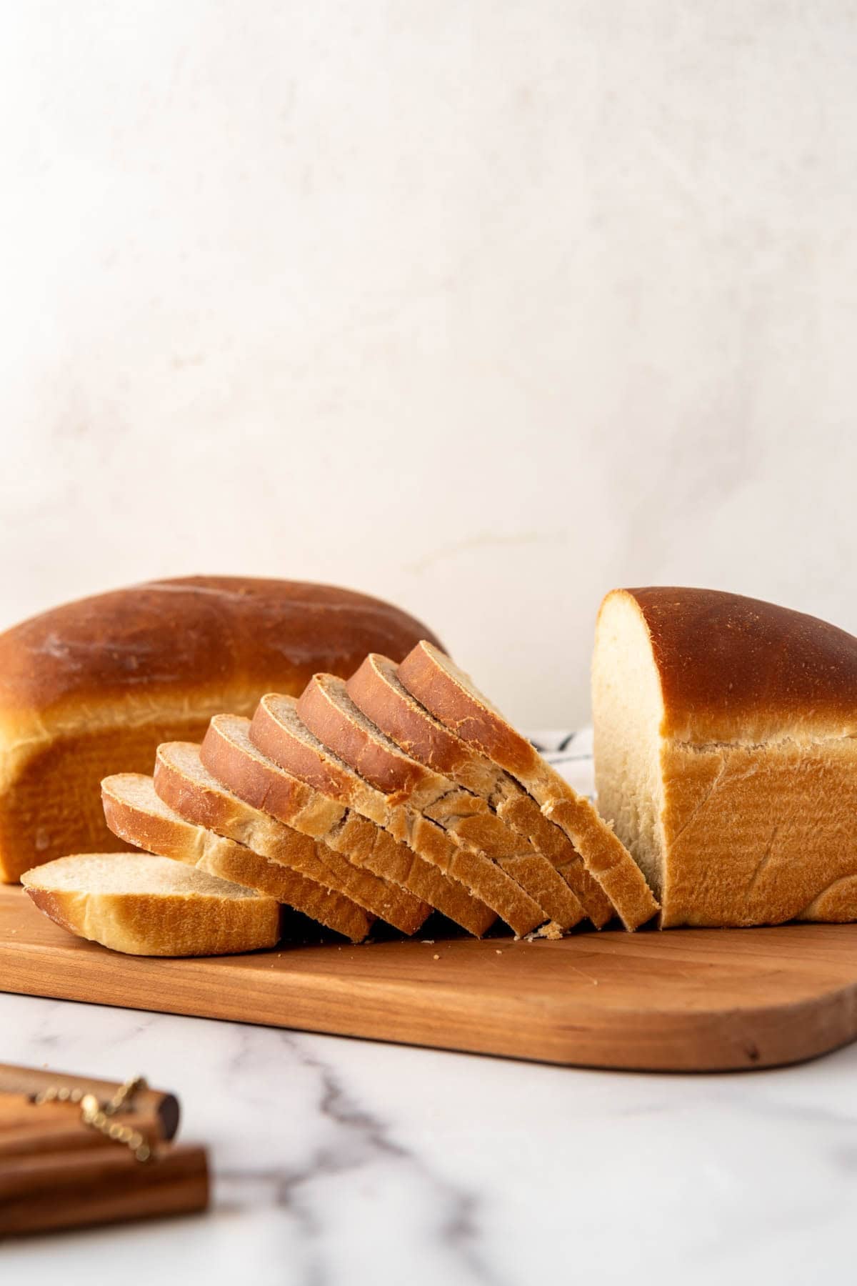 A sliced loaf of sourdough sandwich bread.