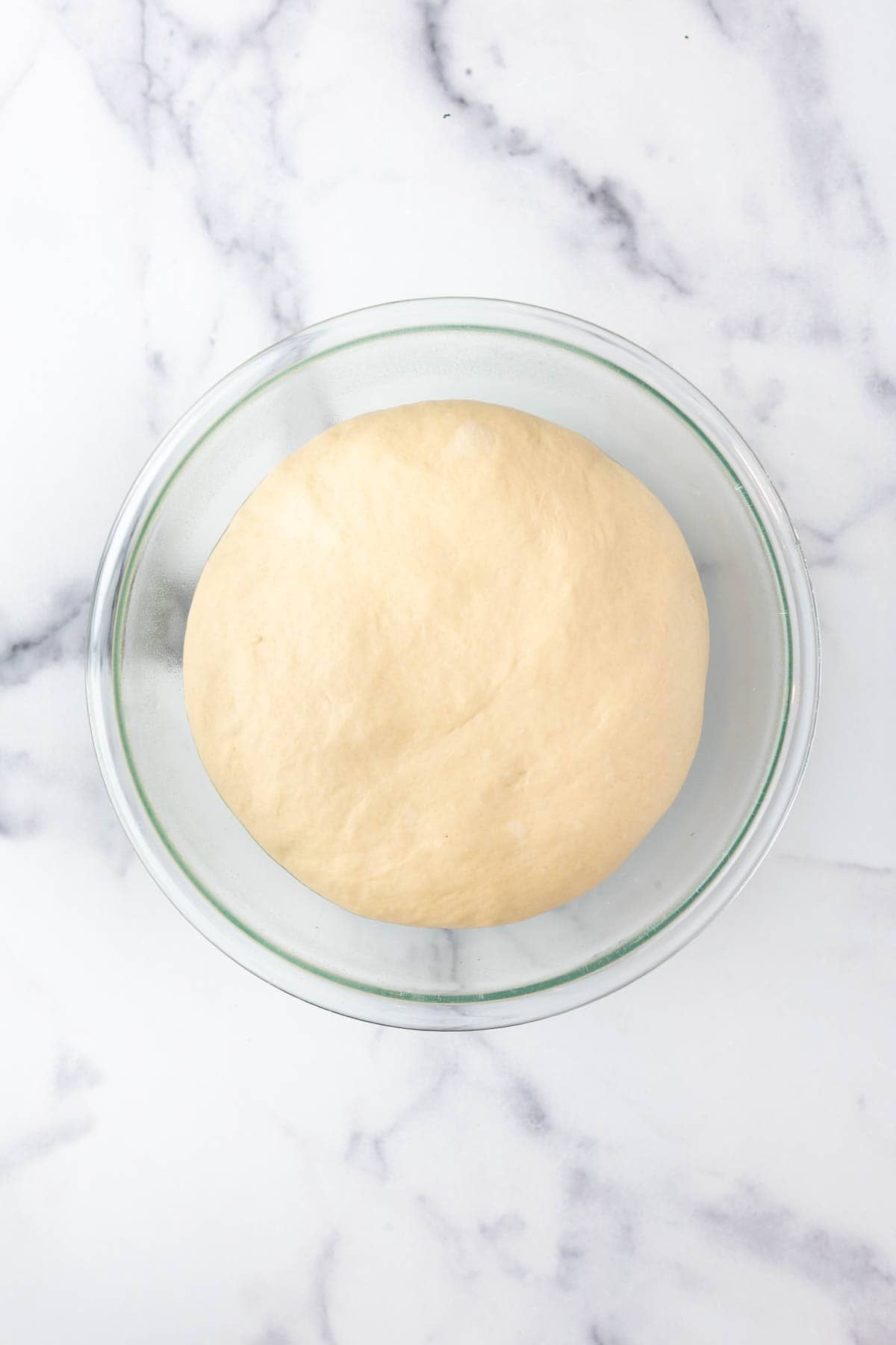 A bowl of sourdough sandwich bread dough that has doubled in size.