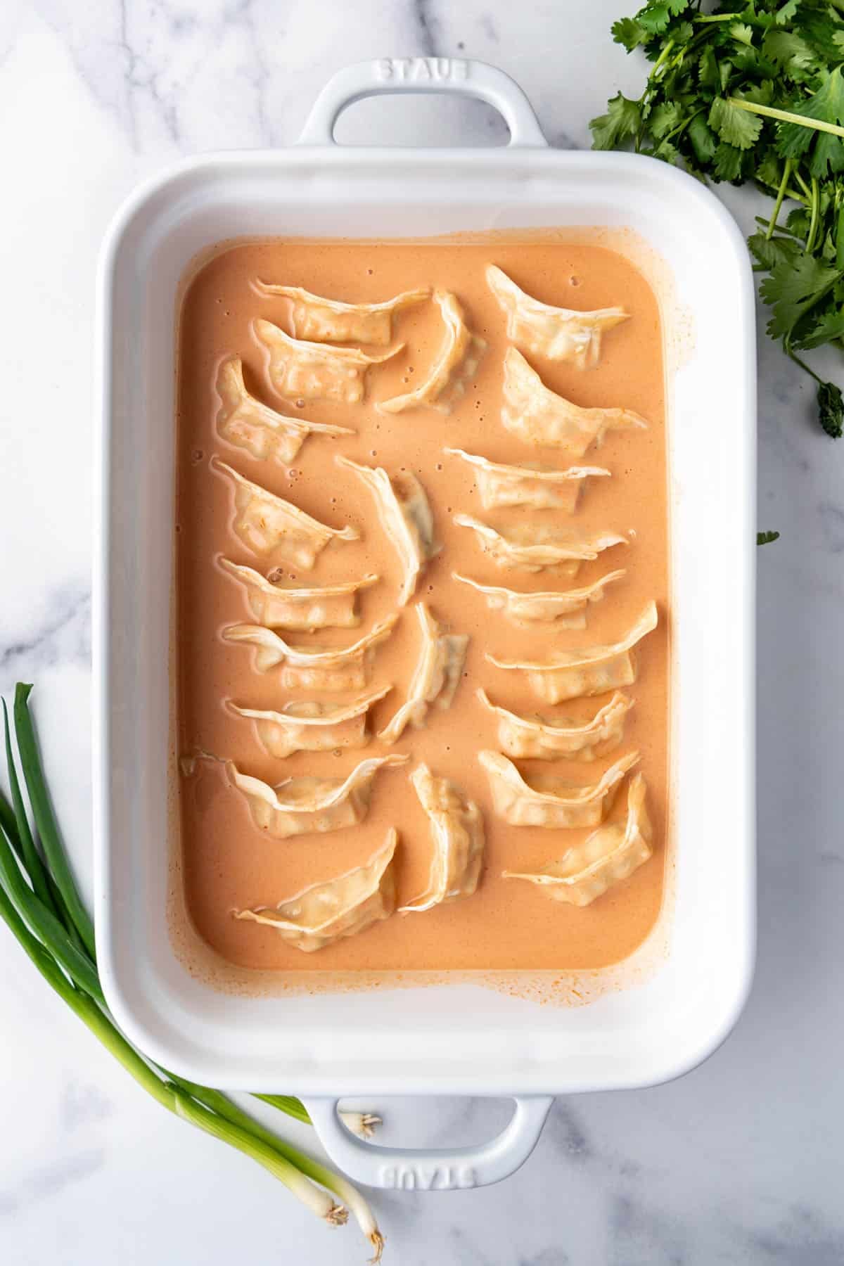Frozen dumplings in a coconut red curry sauce.