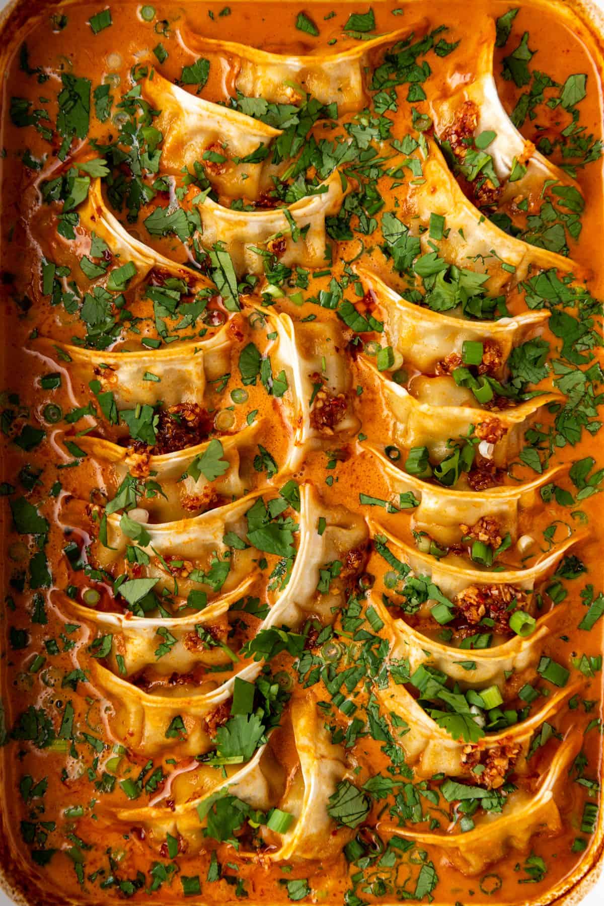 A close-up overhead image of baked dumplings in a casserole dish.