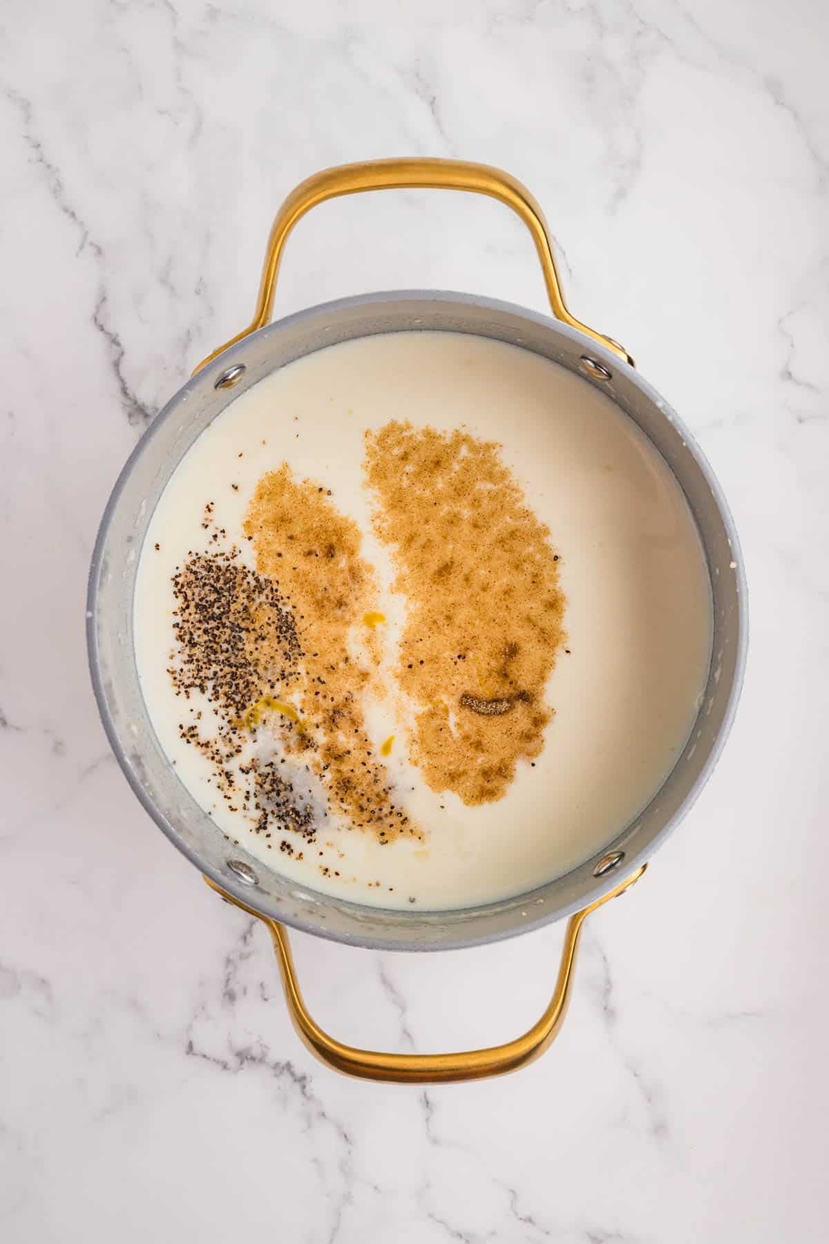 Adding dairy and seasonings to a pot.